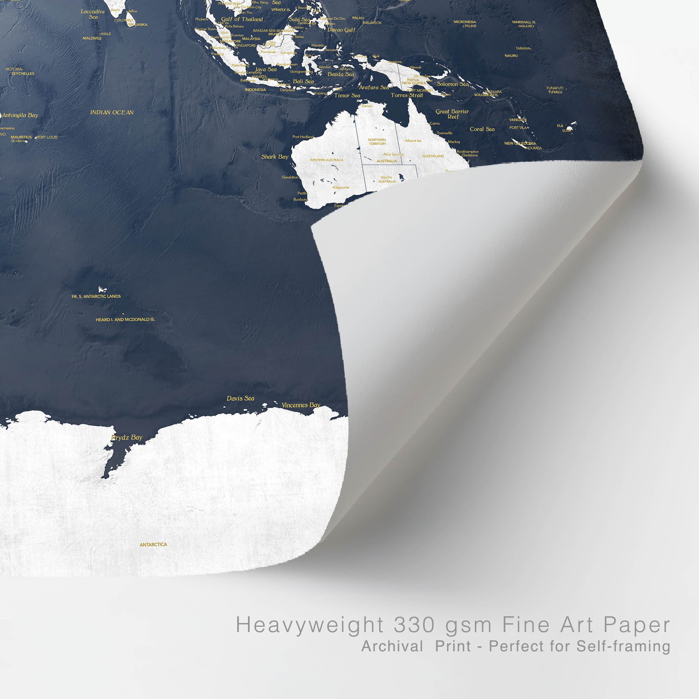 Corner of a navy and gold world map with lifted corner to show heavyweight map print paper - 330 gsm fine art paper