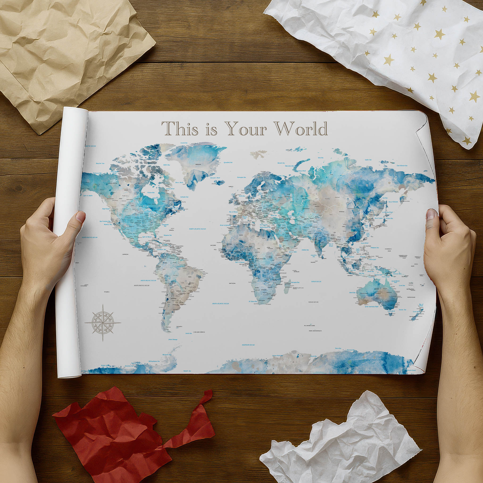 World map with a title text on a wooden surface with decorative items.
